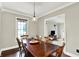 Bright dining room featuring hardwood floors, a window, and a view of living space at 4123 S Village Row, New Palestine, IN 46163