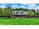 Charming brick home with well-maintained lawn, mature trees, and inviting front porch at 4123 S Village Row, New Palestine, IN 46163