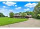 Expansive property featuring a brick home with a large front yard and a circular driveway leading to the garage at 4123 S Village Row, New Palestine, IN 46163