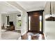 The front door leads into a spacious foyer with hardwood floors and views into the living room at 4123 S Village Row, New Palestine, IN 46163