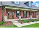 Close-up of the inviting front porch showcasing the wood columns and a beautifully crafted wooden door at 4123 S Village Row, New Palestine, IN 46163