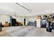 Spacious garage with overhead lighting, door, and storage at 4123 S Village Row, New Palestine, IN 46163
