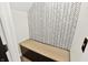 Angle view into a room with a white and gray patterned wallpaper and an integrated bench with storage under at 4123 S Village Row, New Palestine, IN 46163
