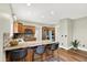Spacious kitchen with breakfast bar, stainless steel appliances, and hardwood floors at 4123 S Village Row, New Palestine, IN 46163