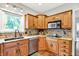Traditional kitchen showcasing wood cabinets, granite countertops, stainless steel appliances, and mosaic backsplash at 4123 S Village Row, New Palestine, IN 46163