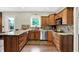 Updated kitchen with granite countertops, mosaic backsplash, stainless appliances, and hardwood floors at 4123 S Village Row, New Palestine, IN 46163
