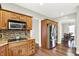 Traditional kitchen showcasing wood cabinets, granite countertops, and stainless steel appliances at 4123 S Village Row, New Palestine, IN 46163