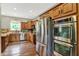 Well-equipped kitchen with stainless steel appliances, hardwood floors, and ample cabinets at 4123 S Village Row, New Palestine, IN 46163
