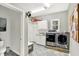Functional laundry room with washer, dryer, storage cabinets, and tile floors at 4123 S Village Row, New Palestine, IN 46163
