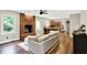 Open living room to kitchen featuring hardwood floors, brick fireplace, and modern finishes at 4123 S Village Row, New Palestine, IN 46163