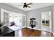 Spacious living room with hardwood floors, French doors, and lots of natural light at 4123 S Village Row, New Palestine, IN 46163
