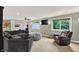 Open living room with comfortable seating, TV, and bright windows at 4123 S Village Row, New Palestine, IN 46163