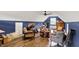 Spacious living room with wood floors, blue walls, bar table, ceiling fan, and comfortable seating at 4123 S Village Row, New Palestine, IN 46163