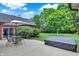 Backyard patio with an outdoor dining set, manicured bushes and yard at 4123 S Village Row, New Palestine, IN 46163