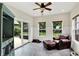Cozy sunroom with a leather chair, lots of natural light, and backyard views at 4123 S Village Row, New Palestine, IN 46163