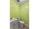 Small bathroom featuring a toilet, sink, and bright yellow walls at 4125 Bowman Ave, Indianapolis, IN 46227