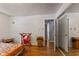 Spacious bedroom featuring hardwood floors, natural light, and mirrored closet doors at 4125 Bowman Ave, Indianapolis, IN 46227