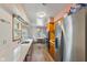 Features a stainless steel refrigerator, a modern sink, wood cabinets, and space for a cozy dining area at 4125 Bowman Ave, Indianapolis, IN 46227