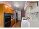 Galley kitchen featuring updated appliances, wooden cabinets, and a bright countertop at 4125 Bowman Ave, Indianapolis, IN 46227
