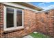 Enclosed backyard with red brick, window and gravel bed at 423 Bent Tree Ln, Indianapolis, IN 46260