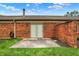 Backyard featuring lush green grass, red brick and sliding glass doors at 423 Bent Tree Ln, Indianapolis, IN 46260