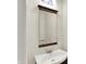 Bathroom with a stylish mirror, vanity sink, and bright lighting at 423 Bent Tree Ln, Indianapolis, IN 46260