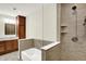 Modern bathroom with a walk-in shower, soaking tub, and vanity with storage at 423 Bent Tree Ln, Indianapolis, IN 46260