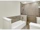 Bright bathroom featuring a tiled walk-in shower and tub with handrails at 423 Bent Tree Ln, Indianapolis, IN 46260