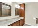 Well-lit bathroom featuring a double vanity with framed mirrors and wooden cabinetry at 423 Bent Tree Ln, Indianapolis, IN 46260