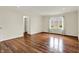 Spacious bedroom with hardwood floors, a window, and a doorway to a closet at 423 Bent Tree Ln, Indianapolis, IN 46260