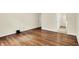 Bedroom with hardwood floors and a doorway with mirror, offering a sense of spaciousness at 423 Bent Tree Ln, Indianapolis, IN 46260