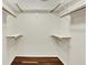Walk-in closet featuring hardwood floors, shelves, and clothes rods for storage at 423 Bent Tree Ln, Indianapolis, IN 46260