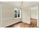 Dining room featuring hardwood floors, crown molding, a window, and a doorway at 423 Bent Tree Ln, Indianapolis, IN 46260