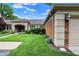 Charming brick home with a tan garage door, manicured lawn and detailed architectural features at 423 Bent Tree Ln, Indianapolis, IN 46260