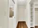 Hallway with hardwood floors, leading to a bathroom, closet, and other rooms at 423 Bent Tree Ln, Indianapolis, IN 46260