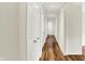 Hallway with hardwood floors and white doors at 423 Bent Tree Ln, Indianapolis, IN 46260