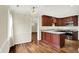 Kitchen with hardwood floors, stainless steel appliances, wooden cabinets, and light countertops at 423 Bent Tree Ln, Indianapolis, IN 46260