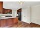 Kitchen with stainless steel refrigerator, wooden cabinets, light countertops and hardwood floors at 423 Bent Tree Ln, Indianapolis, IN 46260