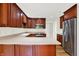 Bright kitchen with stainless steel appliances, wooden cabinets, and light countertops at 423 Bent Tree Ln, Indianapolis, IN 46260