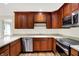 This kitchen features stainless steel appliances, light countertops, and wooden cabinets at 423 Bent Tree Ln, Indianapolis, IN 46260