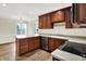 Kitchen with wood cabinets, stainless steel appliances, and granite countertops at 423 Bent Tree Ln, Indianapolis, IN 46260