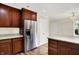 Kitchen with stainless steel refrigerator, wooden cabinets, light countertops and hardwood floors at 423 Bent Tree Ln, Indianapolis, IN 46260