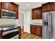 Kitchen with wood cabinets, stainless steel appliances, and granite countertops at 423 Bent Tree Ln, Indianapolis, IN 46260