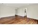 Open living room featuring hardwood floors and neutral walls, with doorways leading to other rooms at 423 Bent Tree Ln, Indianapolis, IN 46260