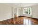 Living room featuring hardwood floors, a modern chandelier and a window with lots of sunlight at 423 Bent Tree Ln, Indianapolis, IN 46260