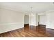 Bright living room featuring hardwood floors, a modern chandelier and white doors and trim at 423 Bent Tree Ln, Indianapolis, IN 46260