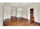 Elegant living room with hardwood floors, a chandelier, and open access to the kitchen at 423 Bent Tree Ln, Indianapolis, IN 46260
