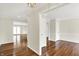 Open-concept living space featuring hardwood floors, white trim, and multiple doorways at 423 Bent Tree Ln, Indianapolis, IN 46260