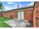 Private patio boasts a brick exterior and sliding glass door access to the interior, perfect for outdoor enjoyment at 423 Bent Tree Ln, Indianapolis, IN 46260