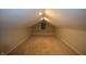 Finished attic with neutral carpet and paint, recessed lighting, and a window at 4231 Carrollton Ave, Indianapolis, IN 46205